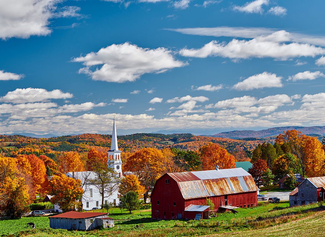 About Our Agency - Congregational Church and Farm With Red Barn at Sunny Autumn Day in Peacham, Vermont
